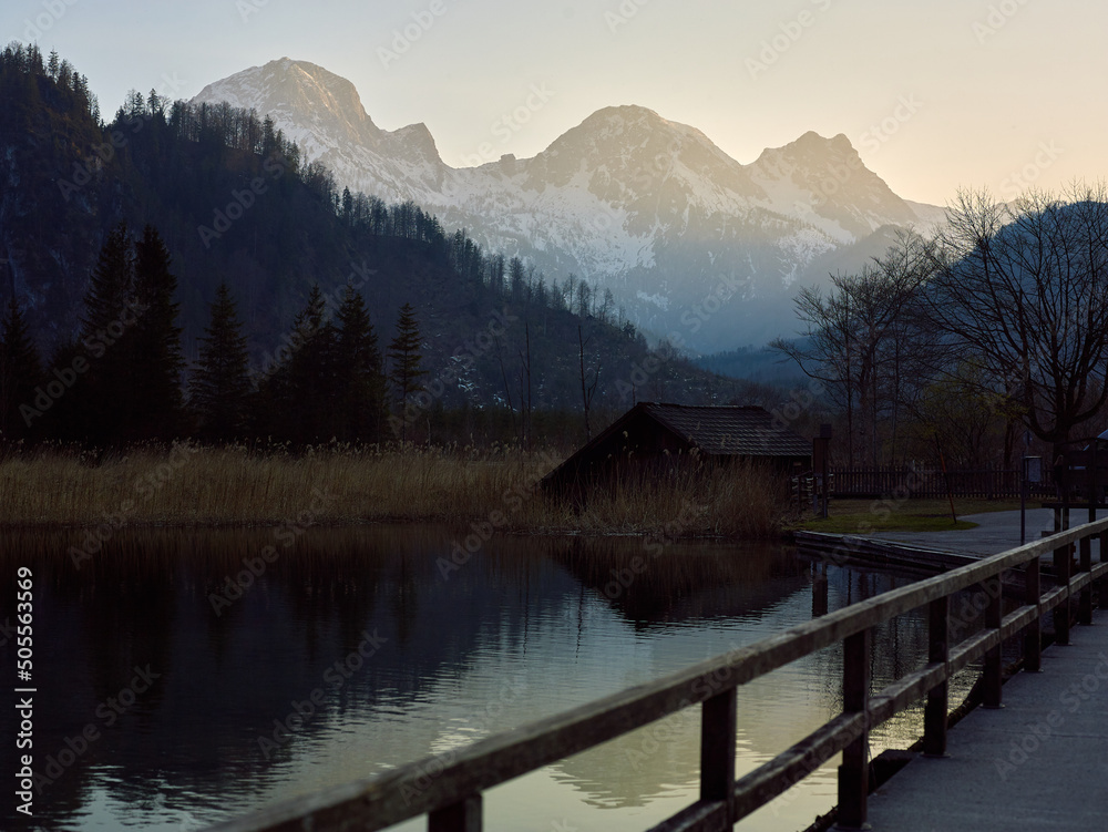 Lake Almsee in Alps mountains, Austria. Foggy sunset landscape.