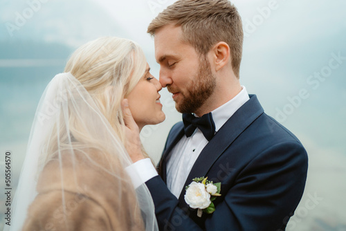 Couple wedding kiss misty mountains and lake