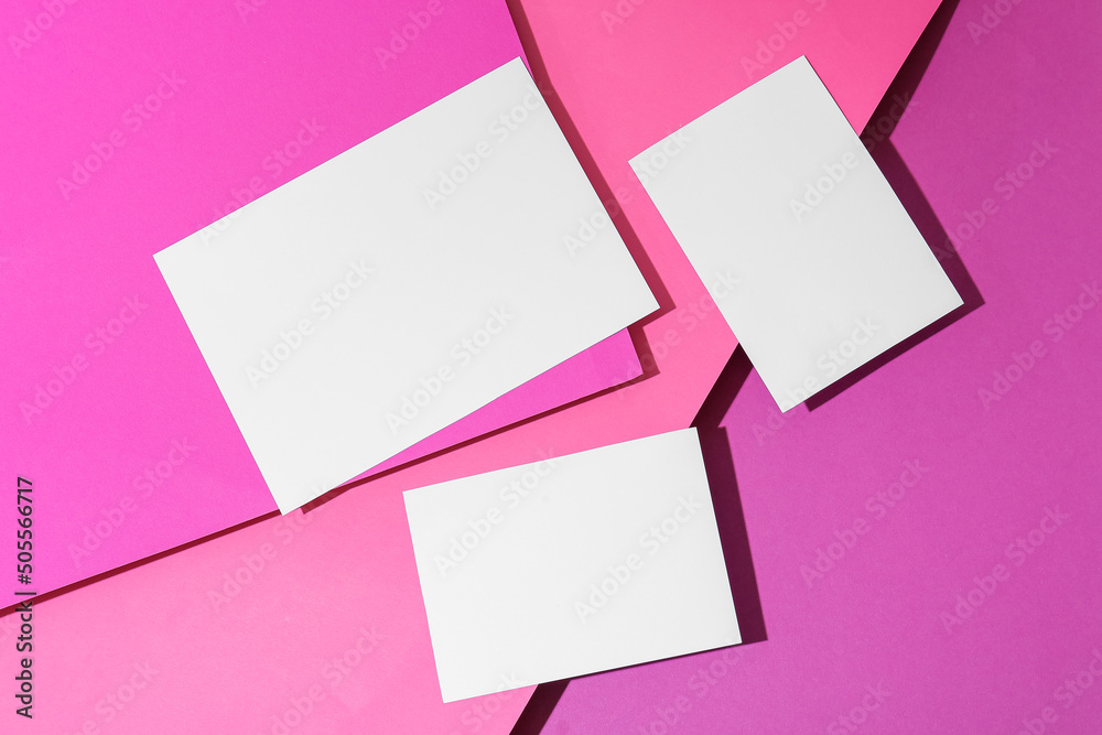 Three white sheets of paper on color background Three white sheets of paper on color background