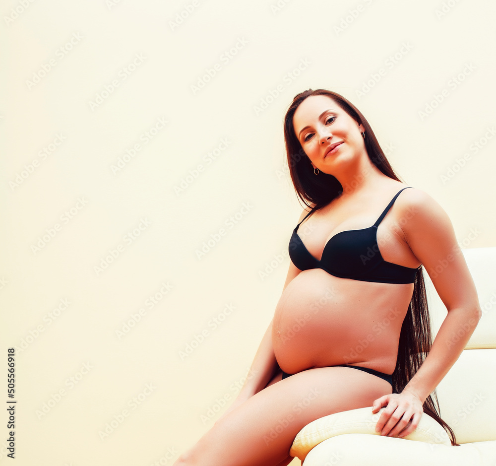 Fototapeta premium young brunette woman at home in chair pregnant, lifestyle people concept