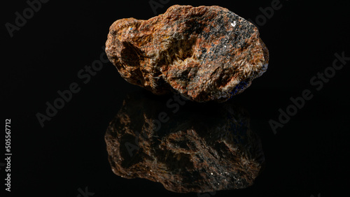 Aged mineral stone with iron ore on a black background photo