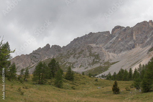 Landscape with mountain massif and green forest in a cloudy day, Dolomites, Italian Alps. photo