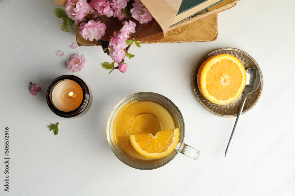 Fotografie Flat lay composition with cup of freshly brewed tea on light table
