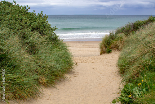 Sand dunes and the beach at Port Ballintrae on the causeway coast in Northern Ireland photo