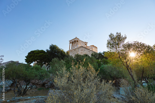 Athens, Greece - July 26, 2021: Temple on top of a hill near the most famous citadel the Parthenon on the hills of Athens, Acropolis. Most visited travel destinations. Tourists from all over the world