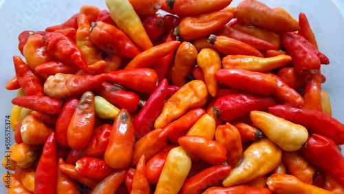 colorful cayenne pepper (cabe setan) seen from above. kitchen spice background concept, cook, cooking, lifestyle, spicy, hot, food, traditional market, hobby, finance, business, appetite enhancer photo