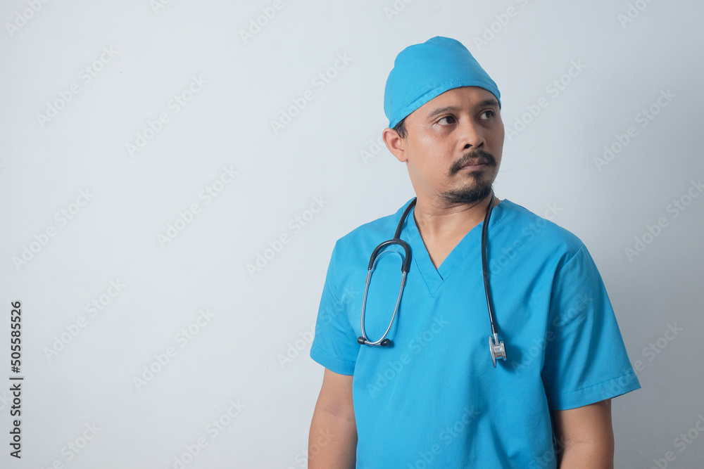 portrait of confident asian male nurse looking away portrait of confident asian male nurse looking away