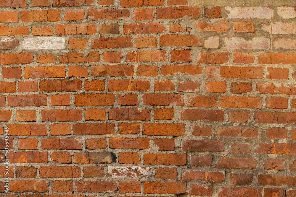 Fototapeta premium Brick red wall. Background of a old brick house.