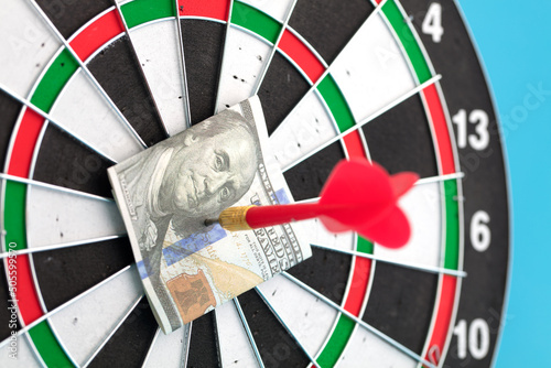 Dart on target hits dollar bill photo