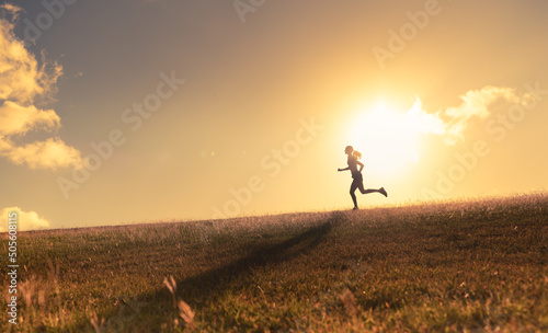 Young woman running, jogging, exercising early morning. Living a healthy active lifestyle concept