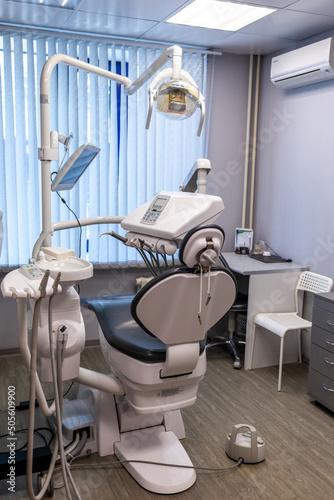 Dental interior office with modern equipment. Modern dental practice. Dental chair and other accessories used by dentists in blue, medic light