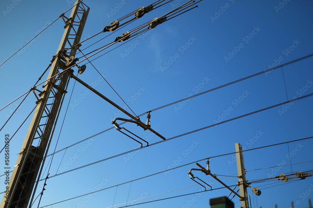 pylons and electric cables above the train tracks pylons and electric cables above the train tracks