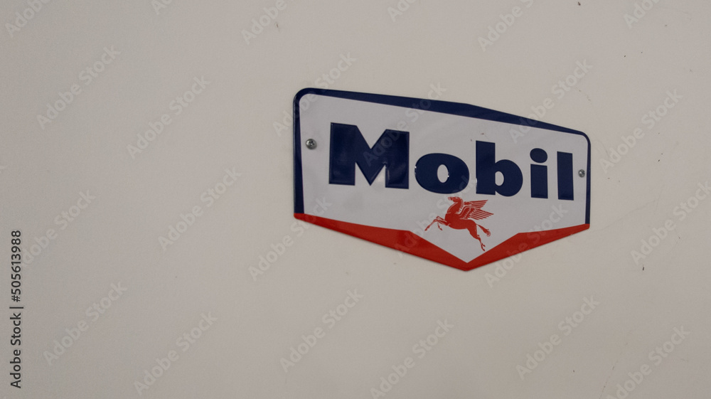 Mobil Oil Gas Station Sign text and brand logo on wall facade Stock