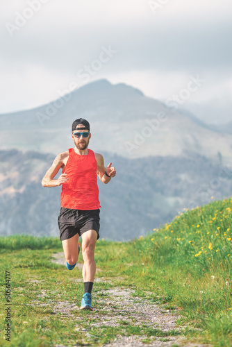 An athlete runs on a mountain dirt road