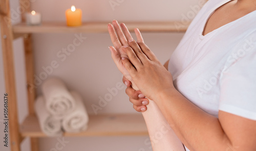 woman hands massage in spa salon, masseur massaging hand and fingers for relaxation, alternative medicine, muscle weakness treatment, health and massage