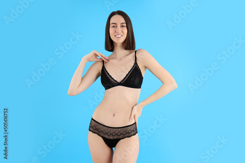 Attractive girl in underwear on blue background