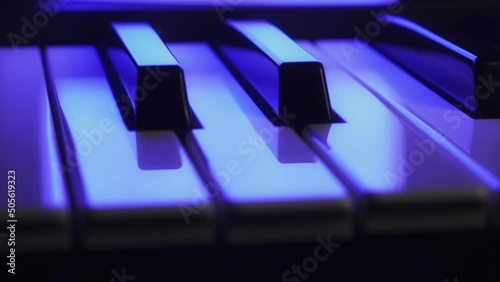 Close up of the keys of a synthesizer keyboard, low angle, moving. photo
