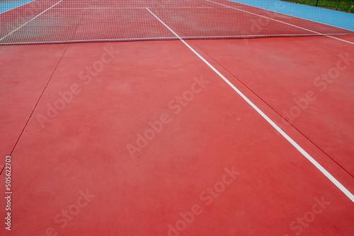Red hard-surface tennis court, racket sports concept