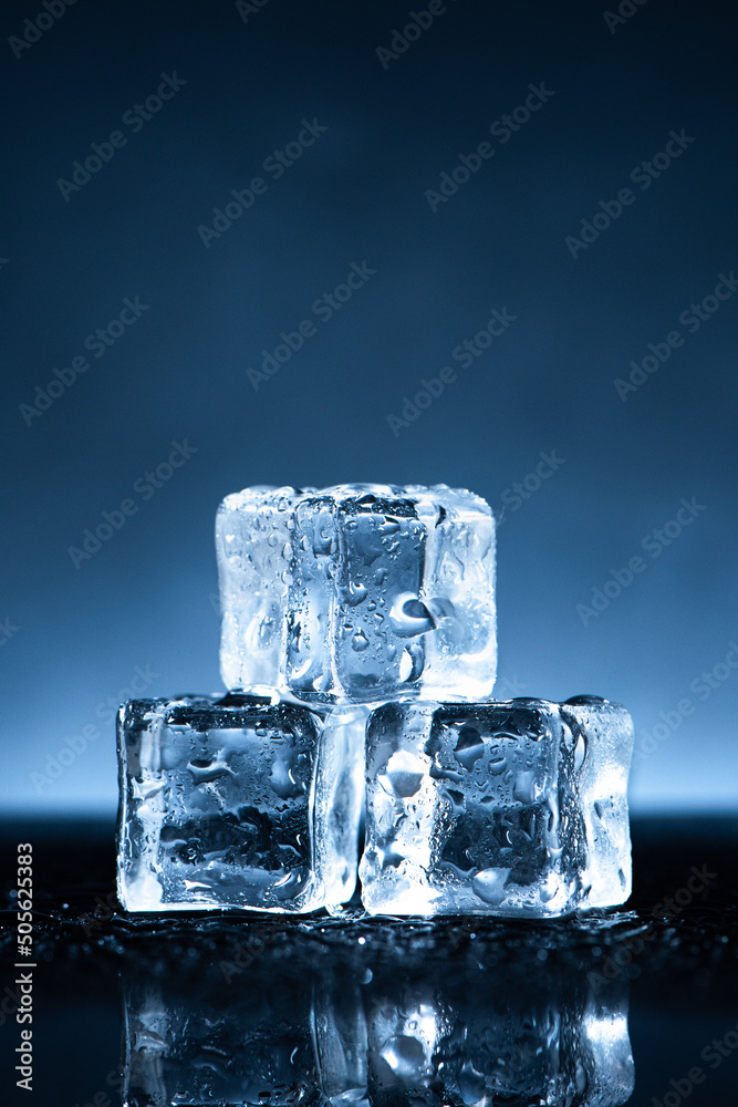 Melting Ice cubes with water drops on reflected glass background Melting Ice cubes with water drops on reflected glass background