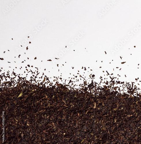 Dry leaves of Darjeeling black tea on white background