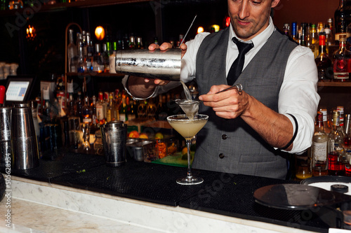 Barman prepares cocktails in the nightclub.