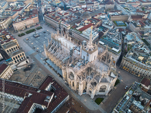 Aerial view of Duomo di Milano Cathedral in Duomo Square. Gothic cathedral in the center of Milan. Drone view of the gallery and Milano rooftops, in north Italy, Lombardia. Birds eye of Duomo facade.