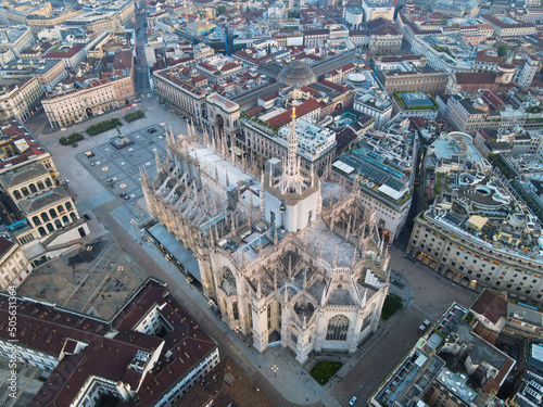 Aerial view of Duomo di Milano Cathedral in Duomo Square. Gothic cathedral in the center of Milan. Drone view of the gallery and Milano rooftops, in north Italy, Lombardia. Birds eye of Duomo facade.