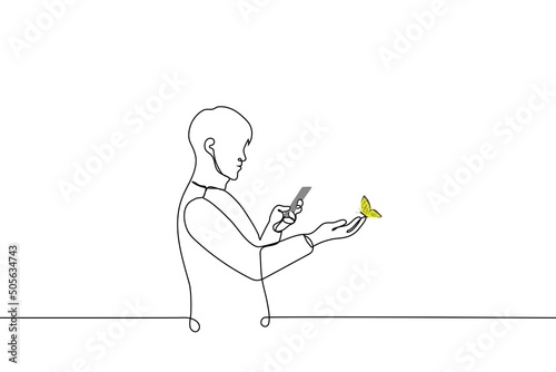 man takes a picture on his phone of a butterfly that landed on his hand - one line drawing vector. concept photography on nature, Entomologist, naturalist blogger