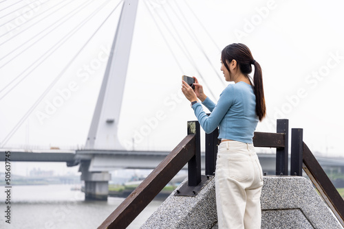 Woman take photo on cellphone in the city photo