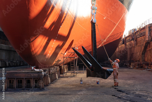 Quadro su tela Workers working in a shipyard and painting in naval industry