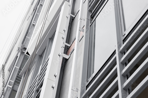 The system of fixing the facade on the building. Aluminum decorative profiles on the building. Modern architectural solutions. Ventilated facade with stone wool insulation and ceramic tiles