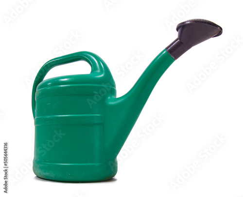 Photo A large plastic green watering can, isolated on a white background
