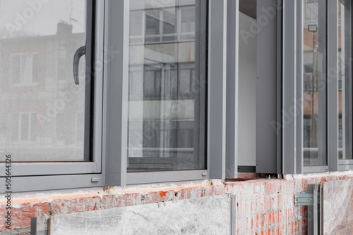 Construction of a building made of brick. Covering the ventilated facade of the house near the window openings. photo