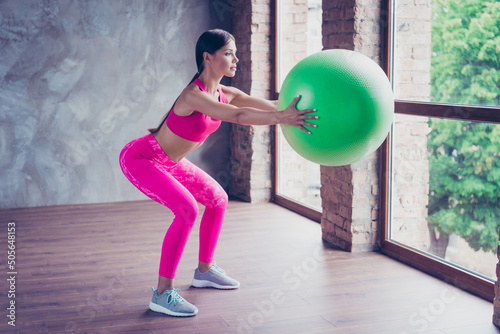 Profile side photo of lady sportsman doing aerobics hold fit ball gear effort endurance in modern loft
