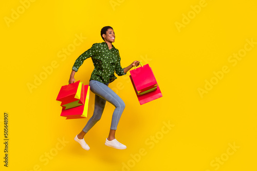 Photo of excited hurrying androgynous person dressed smart casual jumping running fast empty space isolated yellow color background