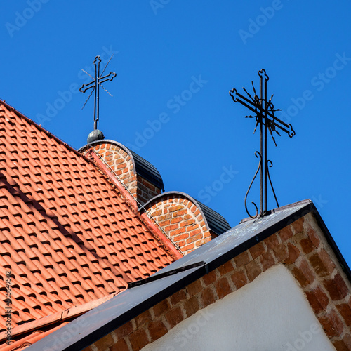 Close-ups of architectural details of the wooden belfry built in the mid-16th century and the brick Catholic church of Saint Stanislaus in the town of Niedzwiadna in Masovia, Poland.