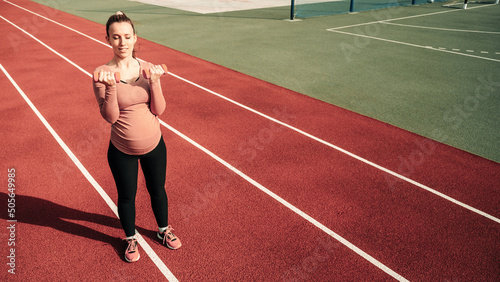 Pregnancy fitness. Prenatal healthy fitness active fit gym outside. Pregnant woman training yoga sport exercise. Prenatal Gymnastics.