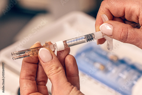 Cosmetician filling the hyaluron pen photo