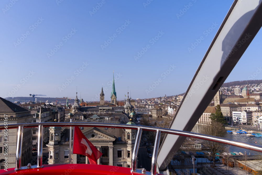 Up in the sky in red ferris wheel cabin looking over the City of Zürich on a beautiful spring day, defocus background. Photo taken March 28th, 2022, Zurich, Switzerland.