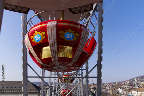 Up in the sky in red ferris wheel cabin looking over the City of Zürich on a beautiful spring day, defocus background. Photo taken March 28th, 2022, Zurich, Switzerland. photo