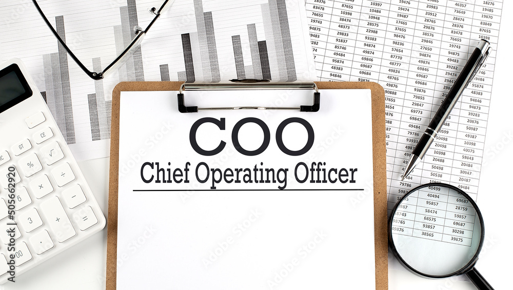 Paper with COO - Chief Operating Officer on a chart with calculator,pen and magnifier - obrazy, fototapety, plakaty 