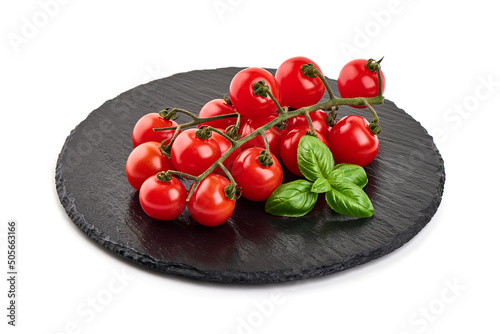 Fresh cherry tomatoes with basil microgreen, isolated on white background.