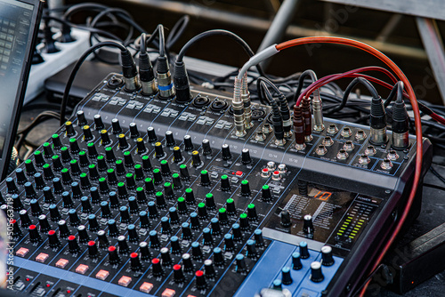Sound audio mixer. General plan of sliders and buttons on a mixing console with connected audio jacks