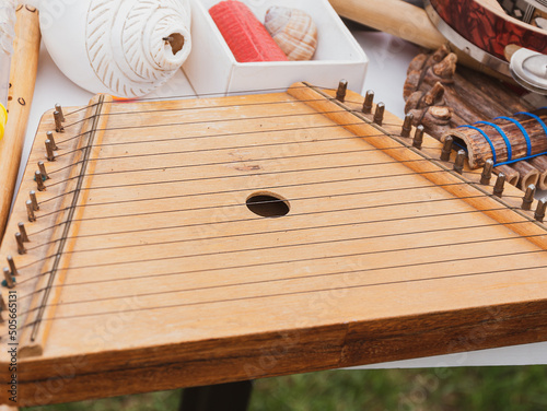 Tsymbaly ethnic musical instrument striking two beaters. Musician man plying ukraininan version of the hammer dulcimer, chordophone trapezoidal box with metal strings.Folk music festival Lviv, Ukraine photo