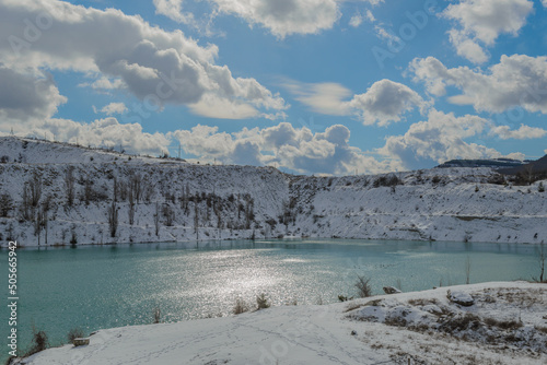 Panorama of the Martian turquoise lake in the Crimea with a view of the snow-covered slopes