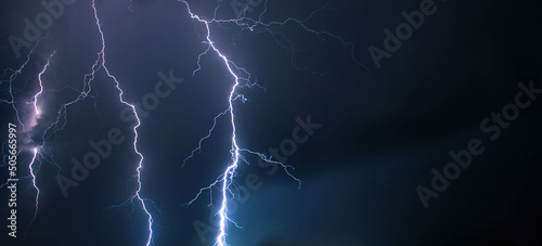 Thunder lightning in the night sky. Beautiful tongues of lightning flashed across the night sky.