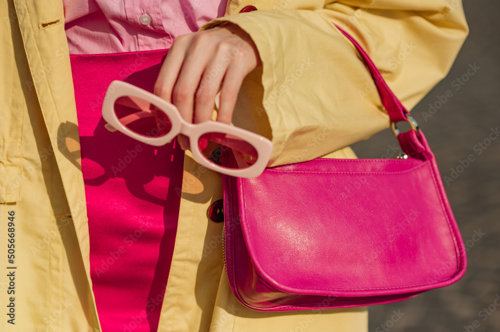 Close up trendy spring fashion outfit with pink, fuchsia color faux leather mini bag, sunglasses - obrazy, fototapety, plakaty 