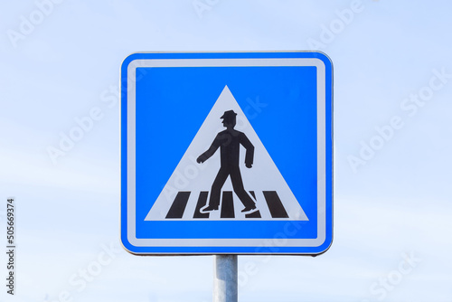 Pedestrian crossing sign on white background close up.