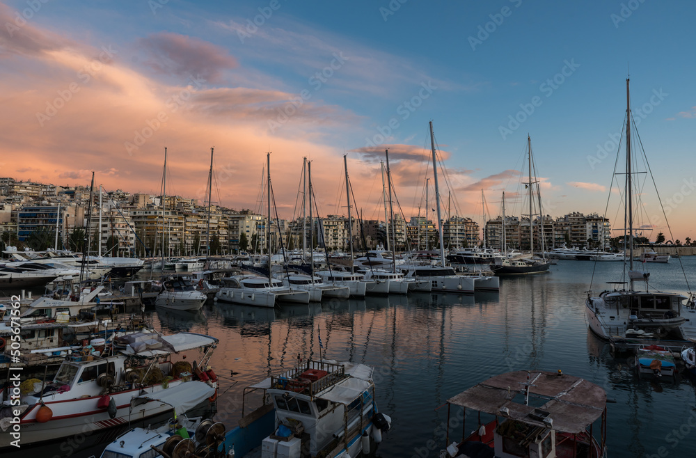 Freattyda, Athens - Greece - Golden hour landscape view over the marina of Piraeus with boats and pink clouds
