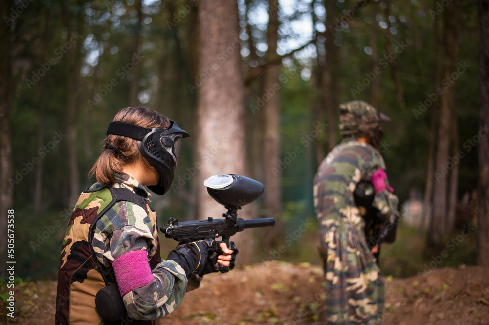 children playing paintball in the forest